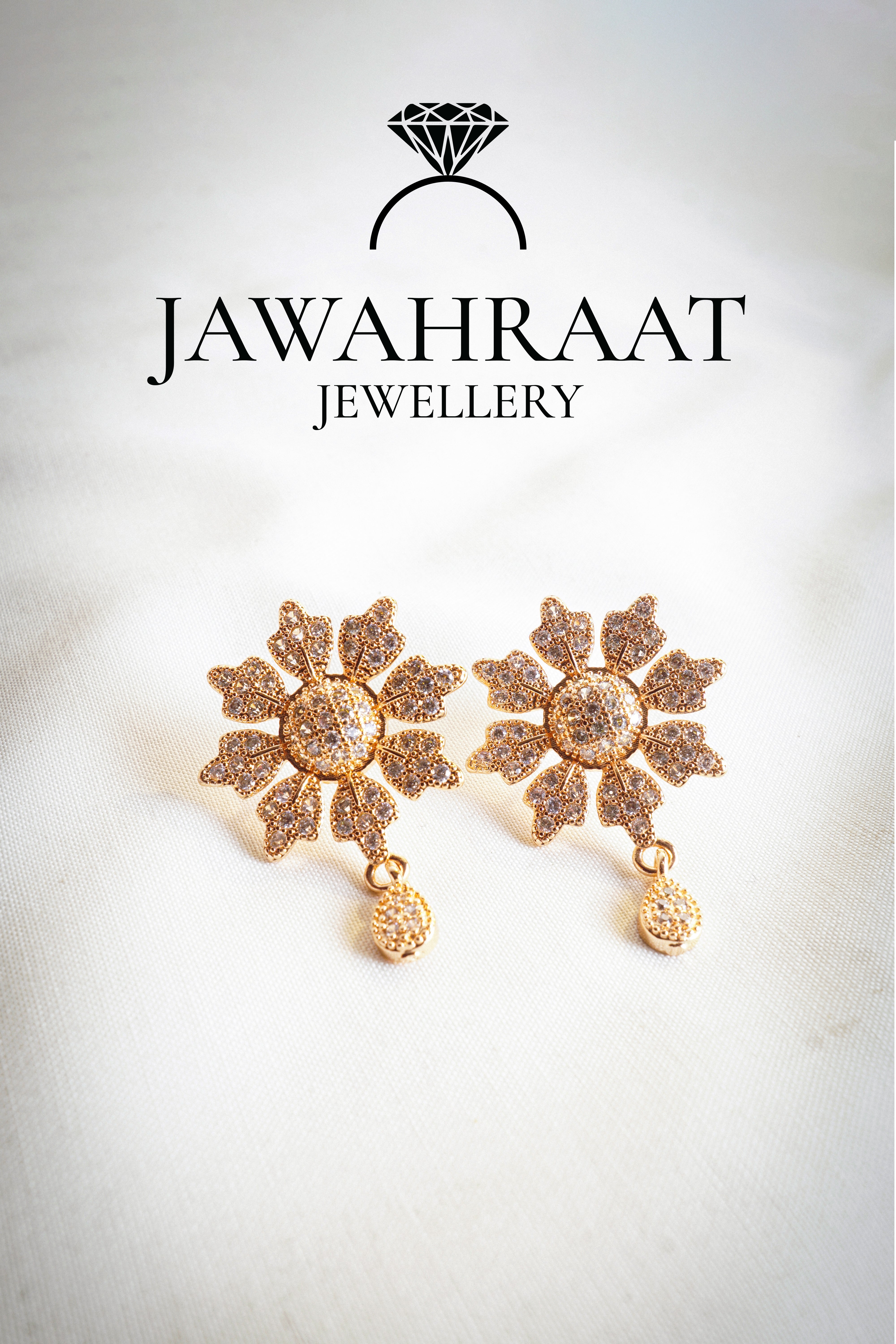 Close-up of gold floral earrings with white stones – elegant artificial jewelry