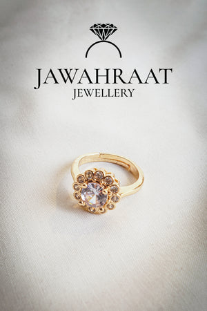 Gold-toned adjustable ring with floral crystal detailing, designed for elegant statement wear