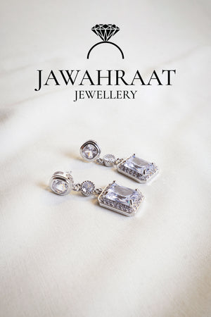 Front view of Crystal Cascade Earrings in silver tone by Jawahraat Jewellery – elegant drop earrings with cascading crystals in a striking multi-shape layout and pave accents.