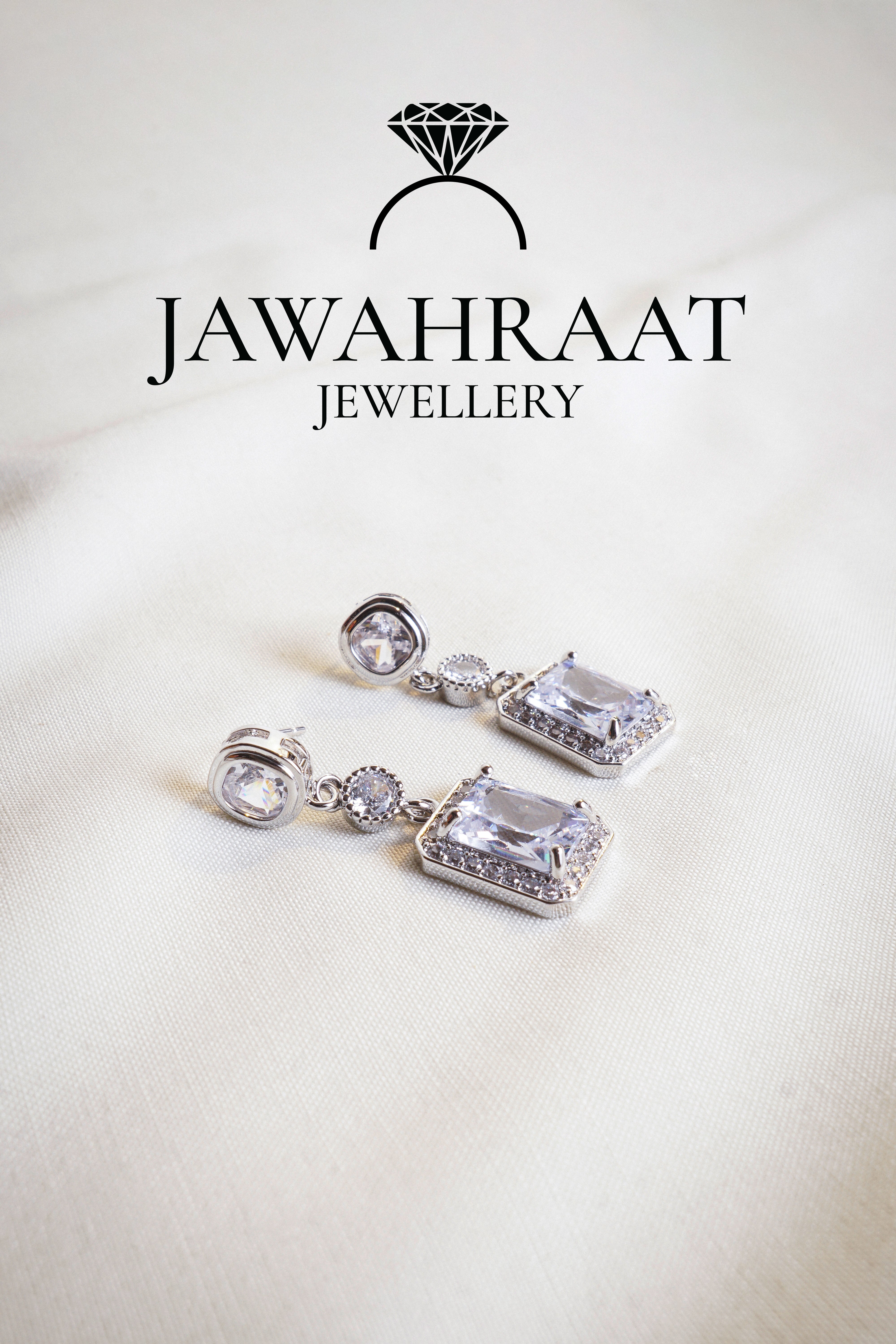 Front view of Crystal Cascade Earrings in silver tone by Jawahraat Jewellery – elegant drop earrings with cascading crystals in a striking multi-shape layout and pave accents.