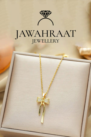 Front view of gold bow pendant necklace by Jawahraat Jewellery, featuring a delicate design with sparkling cubic zirconia stones and a lightweight chain.