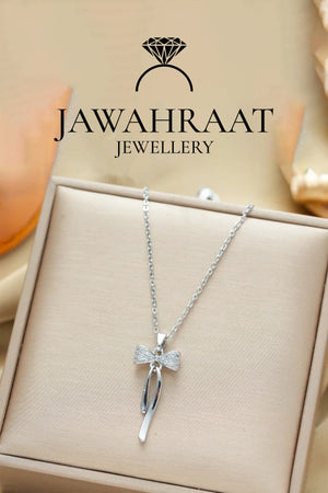 Front view of silver bow pendant necklace by Jawahraat Jewellery, featuring a graceful bow design adorned with cubic zirconia stones, ideal for elegant styling.