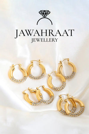 Front view of gold-toned crystal hoop earrings by Jawahraat Jewellery, featuring a classic circular shape with sparkling clear crystals set in polished stainless steel.