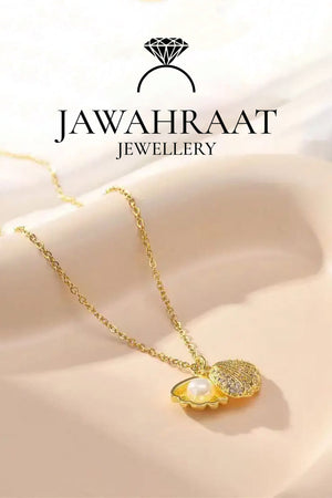 Side view of the Golden Seashell Pearl Pendant Necklace by Jawahraat Jewellery, showing the curved open shell design and centered faux pearl in a gold-tone finish.