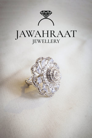 Side view of a silver-tone floral cocktail ring by Jawahraat Jewellery, showcasing its raised floral design with sparkling baguette and pave crystals.