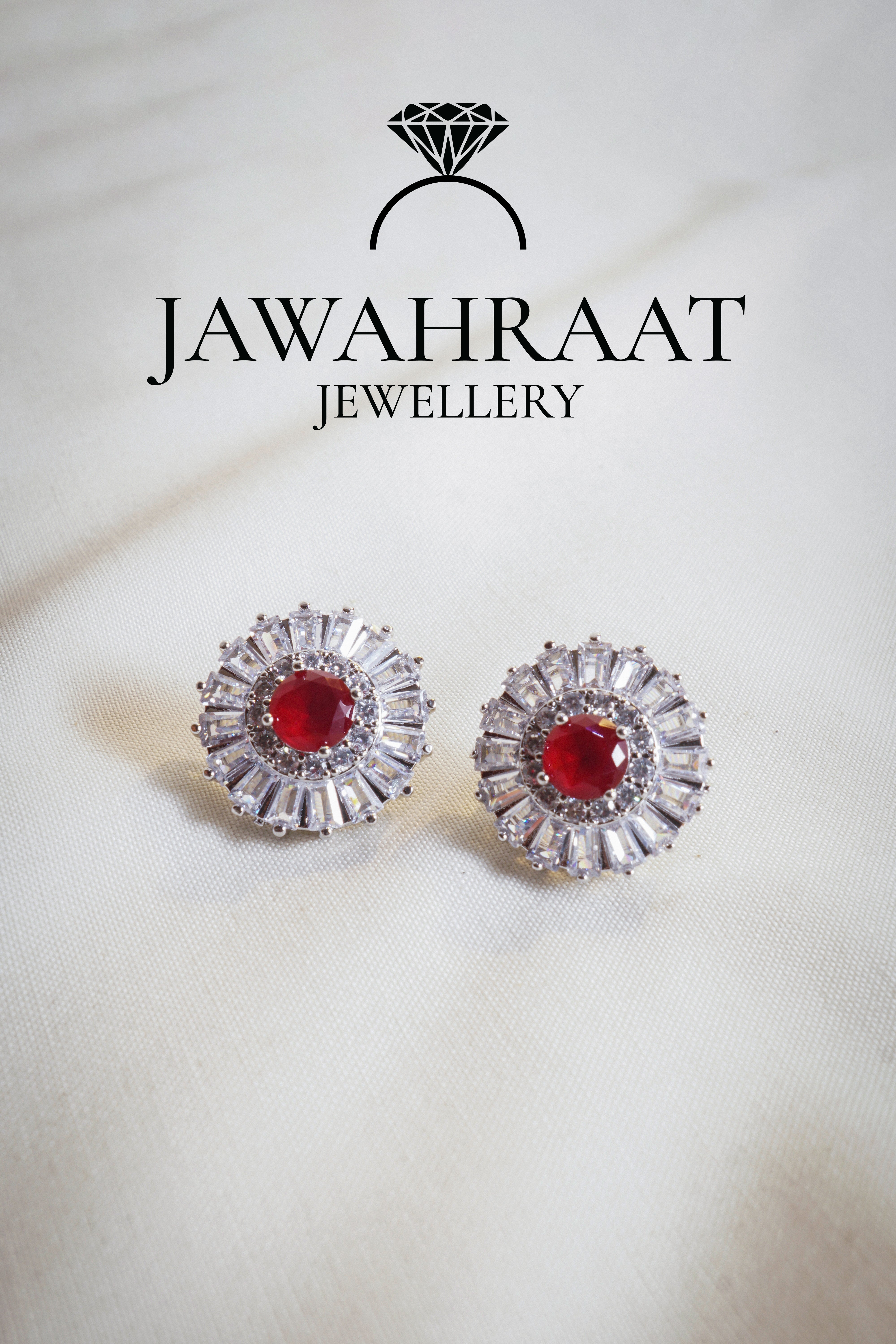 Silver teardrop earrings with red stones and crystal detailing, ideal for formal and festive wear