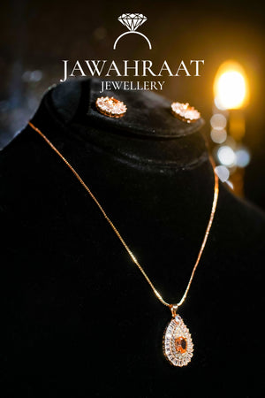 Gold-toned necklace with soft peach teardrop stone pendant and crystal accents, elegant bridal jewelry