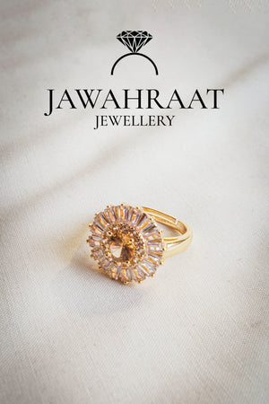 Adjustable gold-tone ring featuring a peach teardrop stone in a royal setting with crystal detail