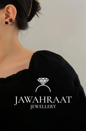 Elegant black flower and pearl stud earrings worn on ear, artificial jewellery by Jawahraat Jewellery