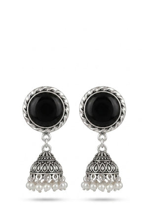Close-up of oxidized silver jhumka earrings with black stone centerpiece and pearl detailing