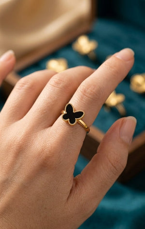 Gold plated butterfly ring with black inlay worn on finger