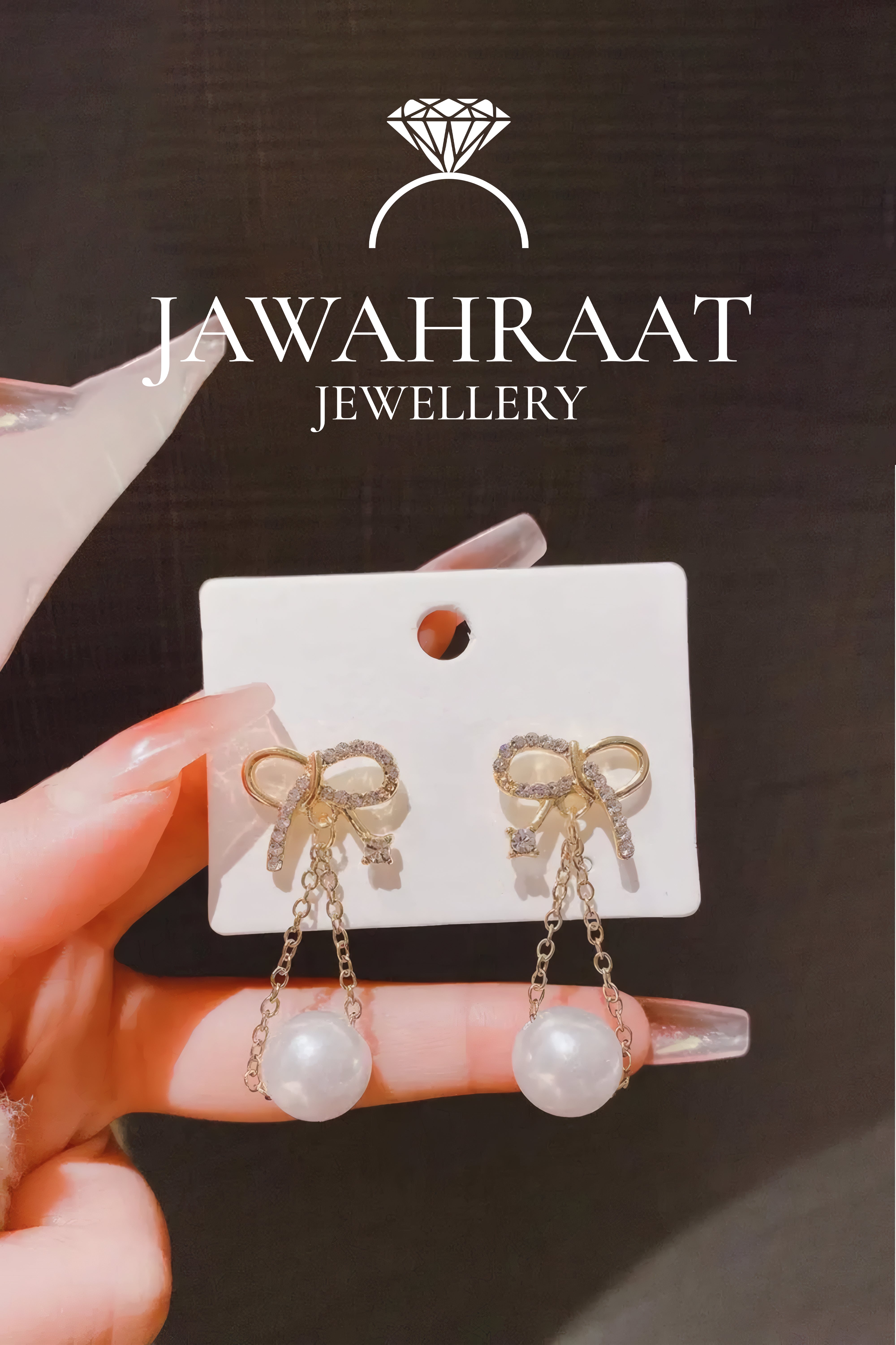 Gold bow pearl drop earrings with CZ crystals and faux pearl from Jawahraat Jewellery artificial jewellery
