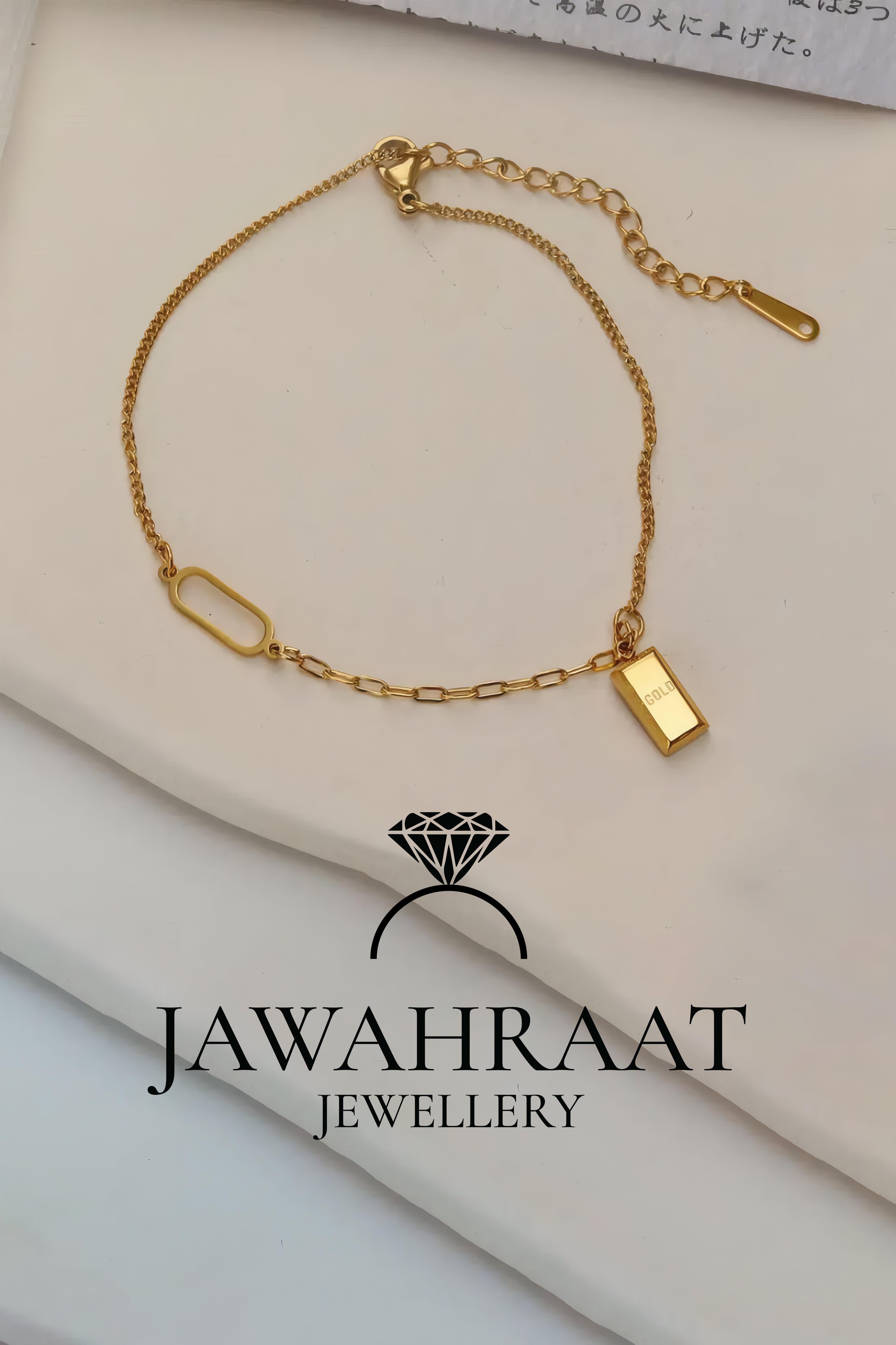 Close-up of adjustable gold "GOLD" bar charm chain, wearable as bracelet or anklet, artificial jewelry by Jawahraat Jewellery