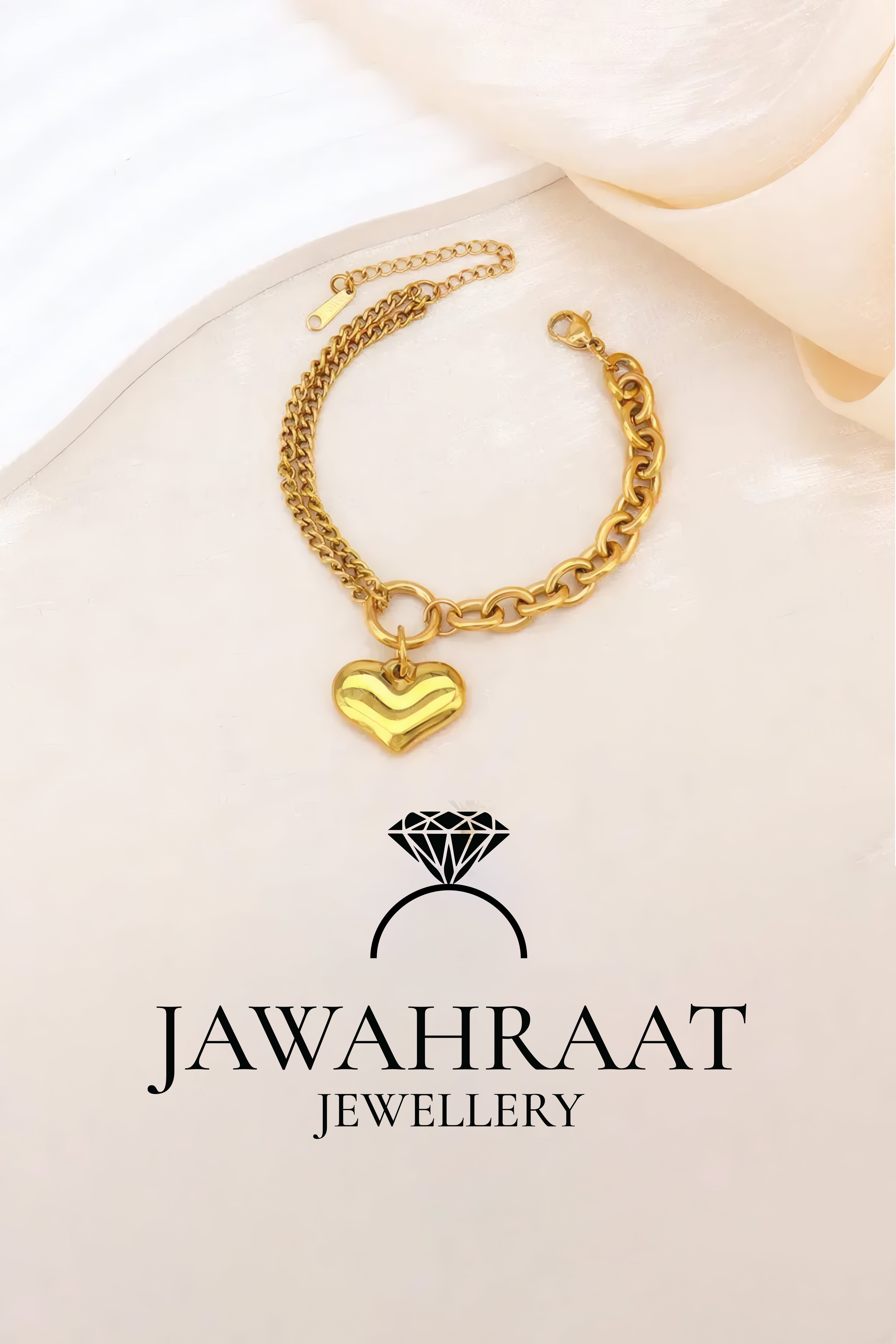 Woman wearing gold layered chain bracelet with heart pendant, artificial jewelry from Jawahraat Jewellery