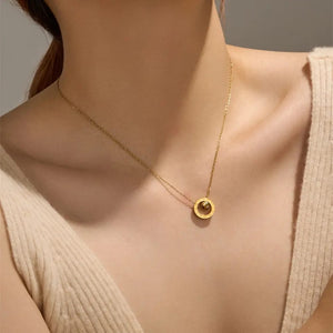 Woman wearing gold Roman numeral double ring pendant necklace