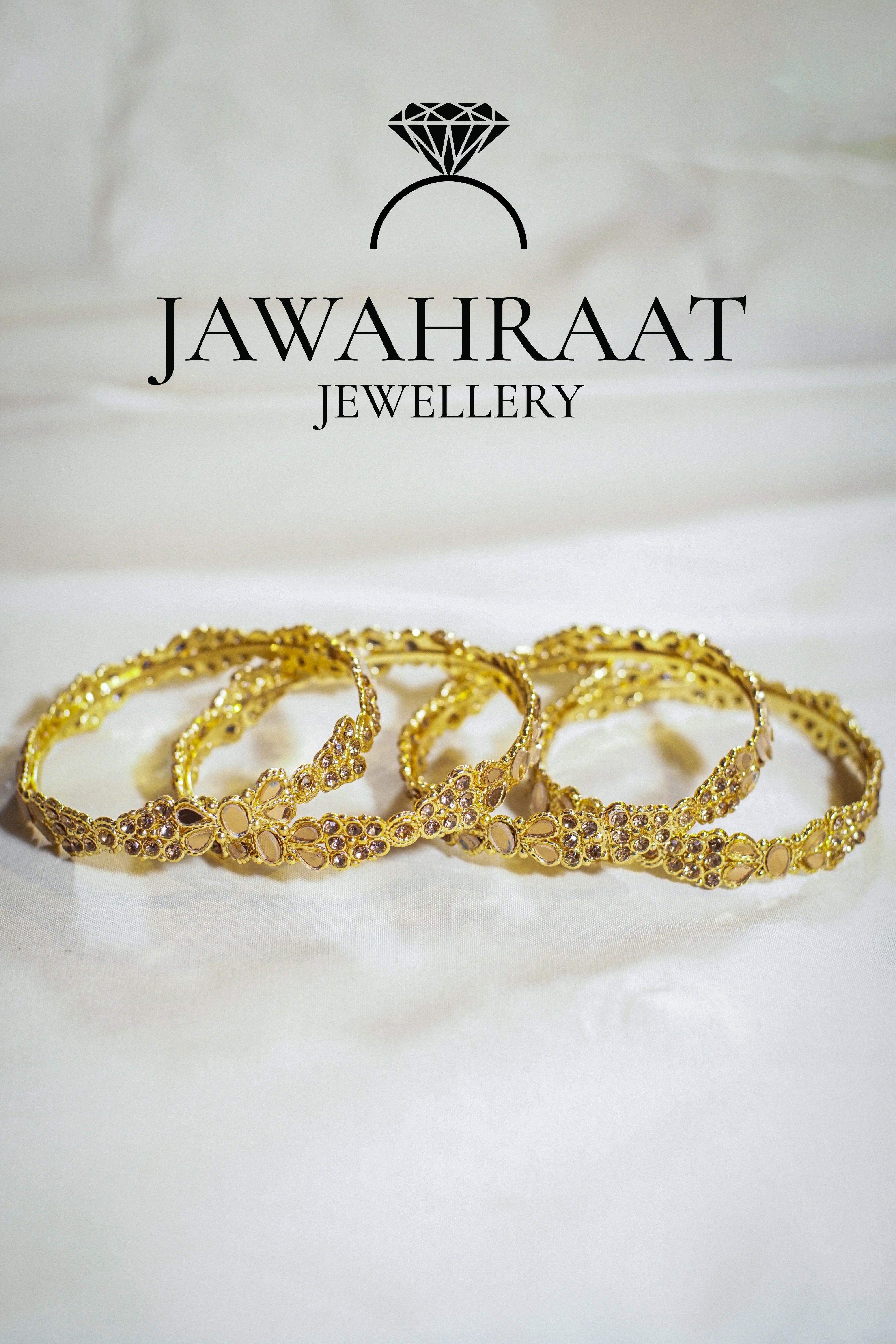 Set of 4 gold-tone designer bangles with intricate patterns and crystal bead accents – artificial jewellery by Jawahraat

