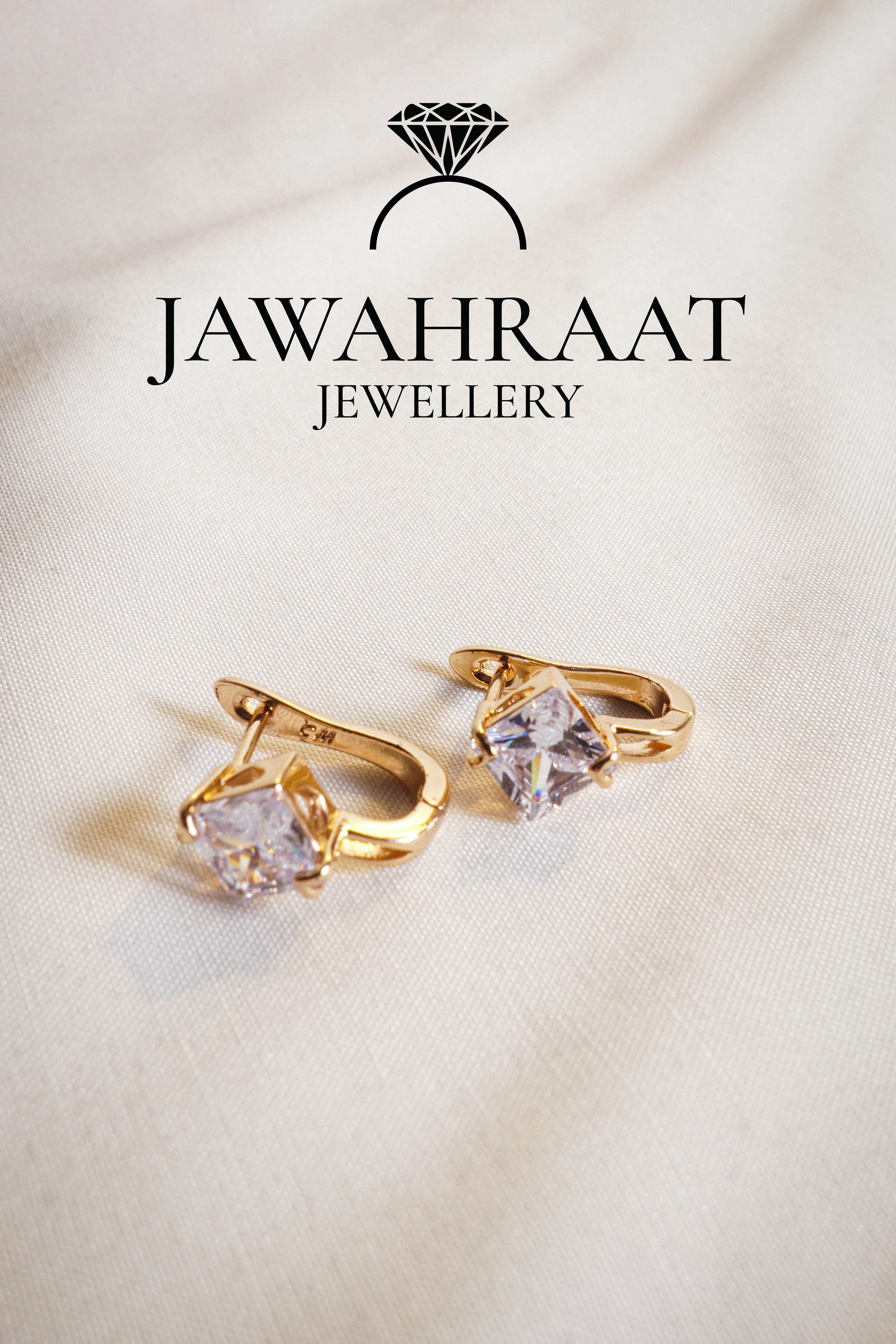 Close-up of gold-tone huggie hoop earrings featuring square-cut crystal centerpiece – stylish daily wear jewellery from Jawahraat