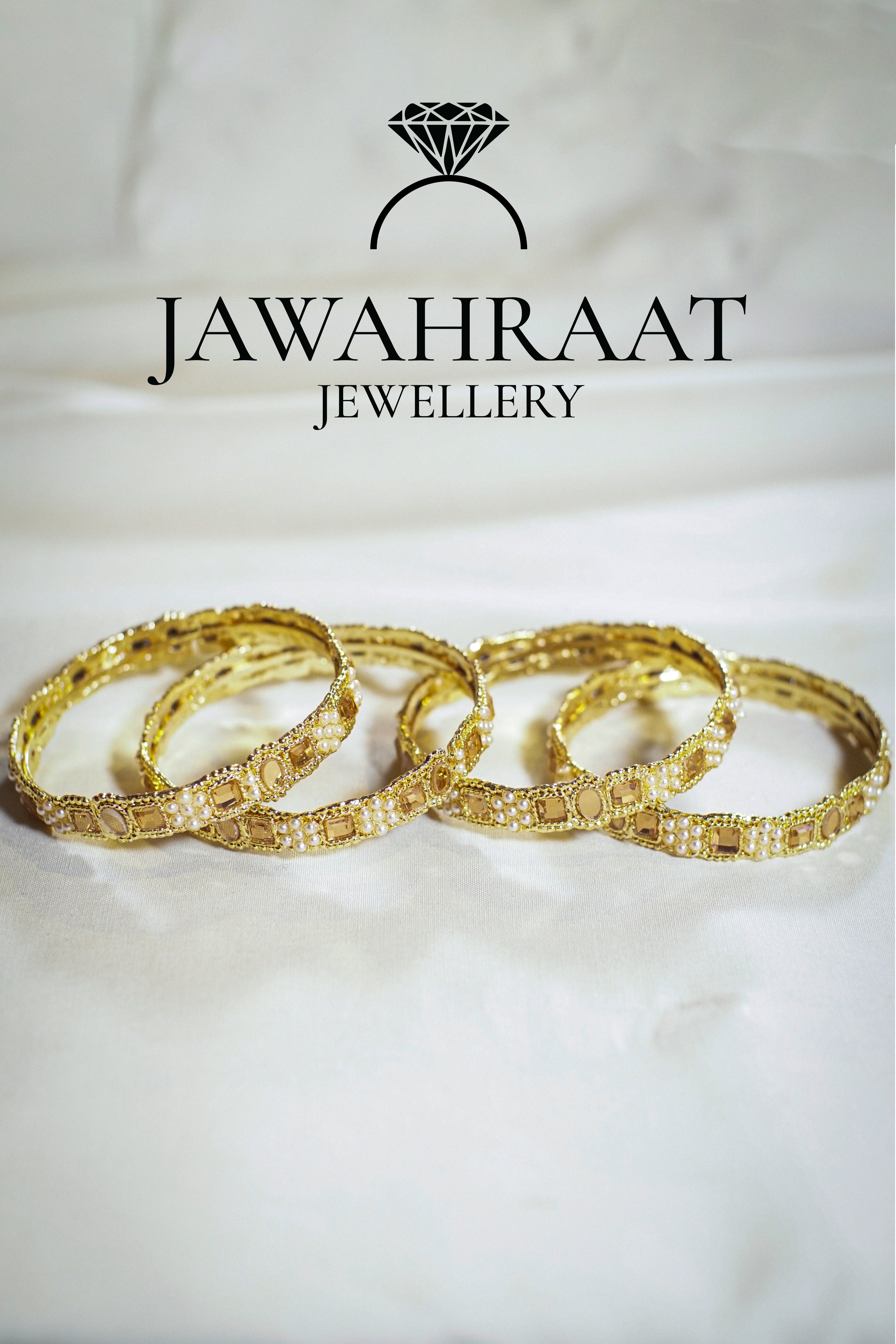 Set of gold-tone bangles featuring pearl and crystal stone accents in size 2.4 from Jawahraat Jewellery

