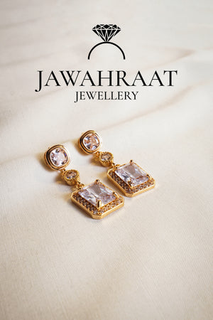 Front view of Crystal Cascade Earrings in gold tone by Jawahraat Jewellery – featuring a tiered design with square, round, and rectangular crystals, accented with pave details.

