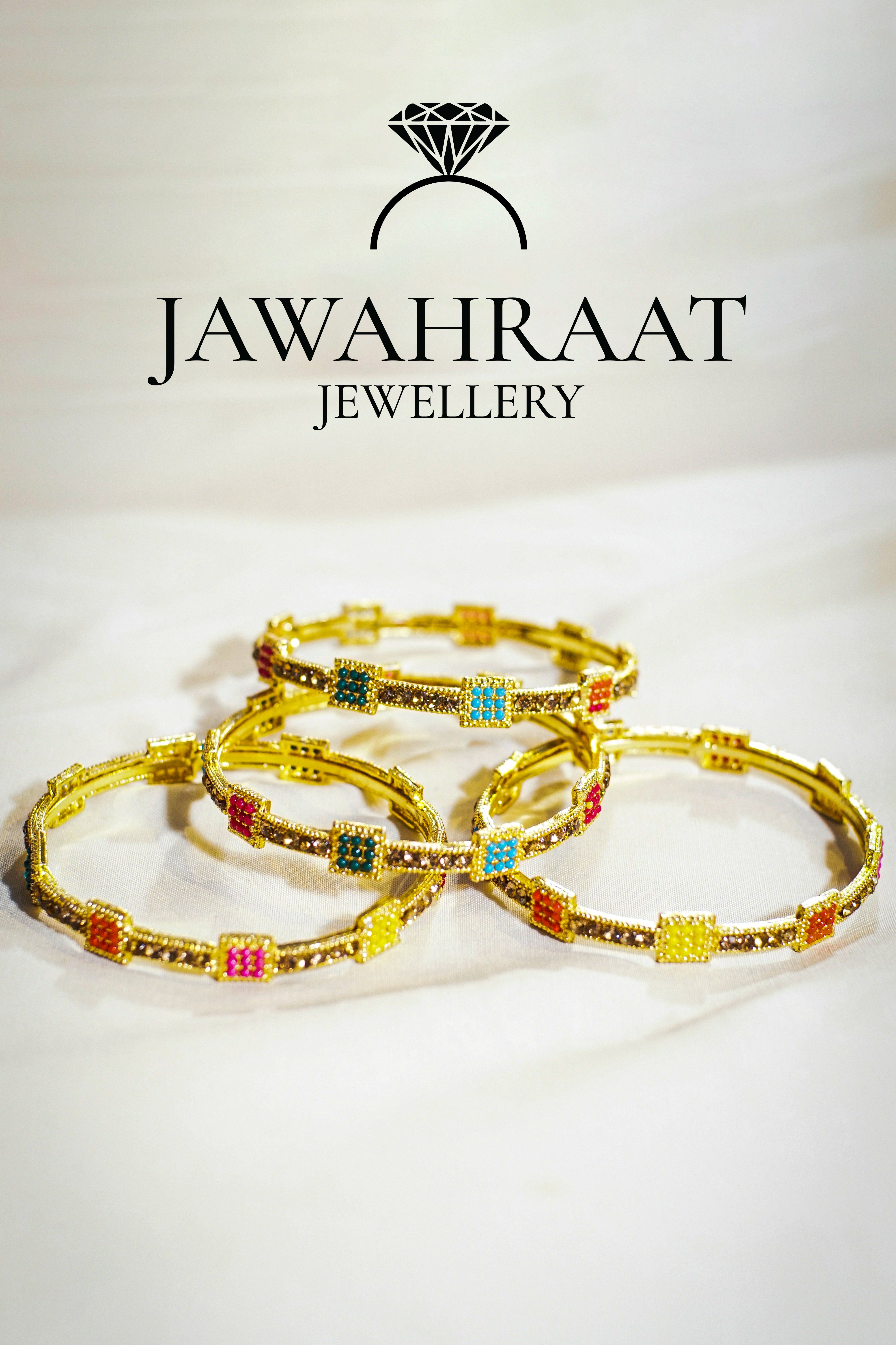 Gold-tone bangles by Jawahraat Jewellery featuring colorful square-cut stones in pink, green, yellow, and blue. Elegant and perfect for stacking.

