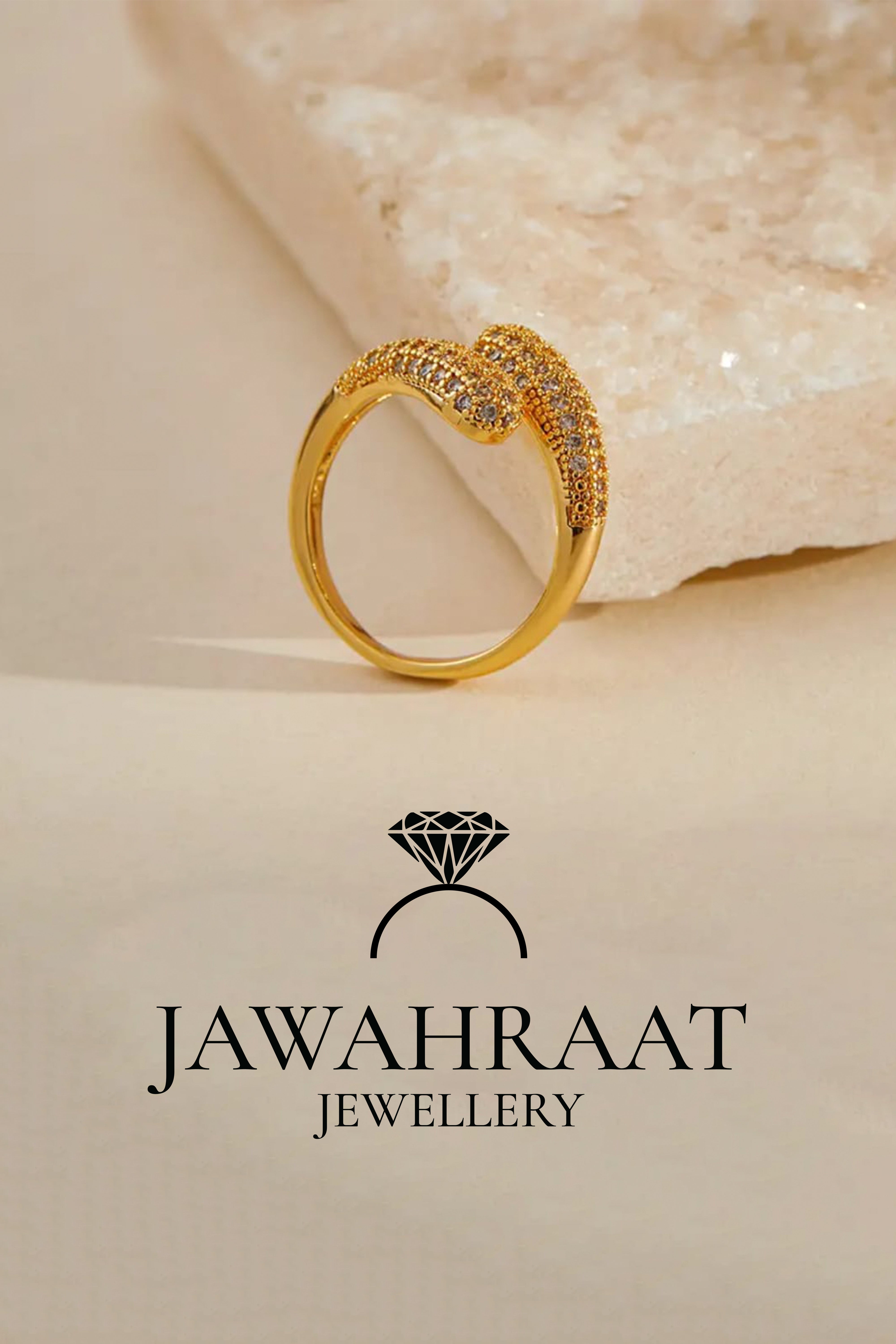Side view of gold-toned twist ring by Jawahraat Jewellery, displayed upright to highlight its unique twisted design and embedded sparkling crystals.


