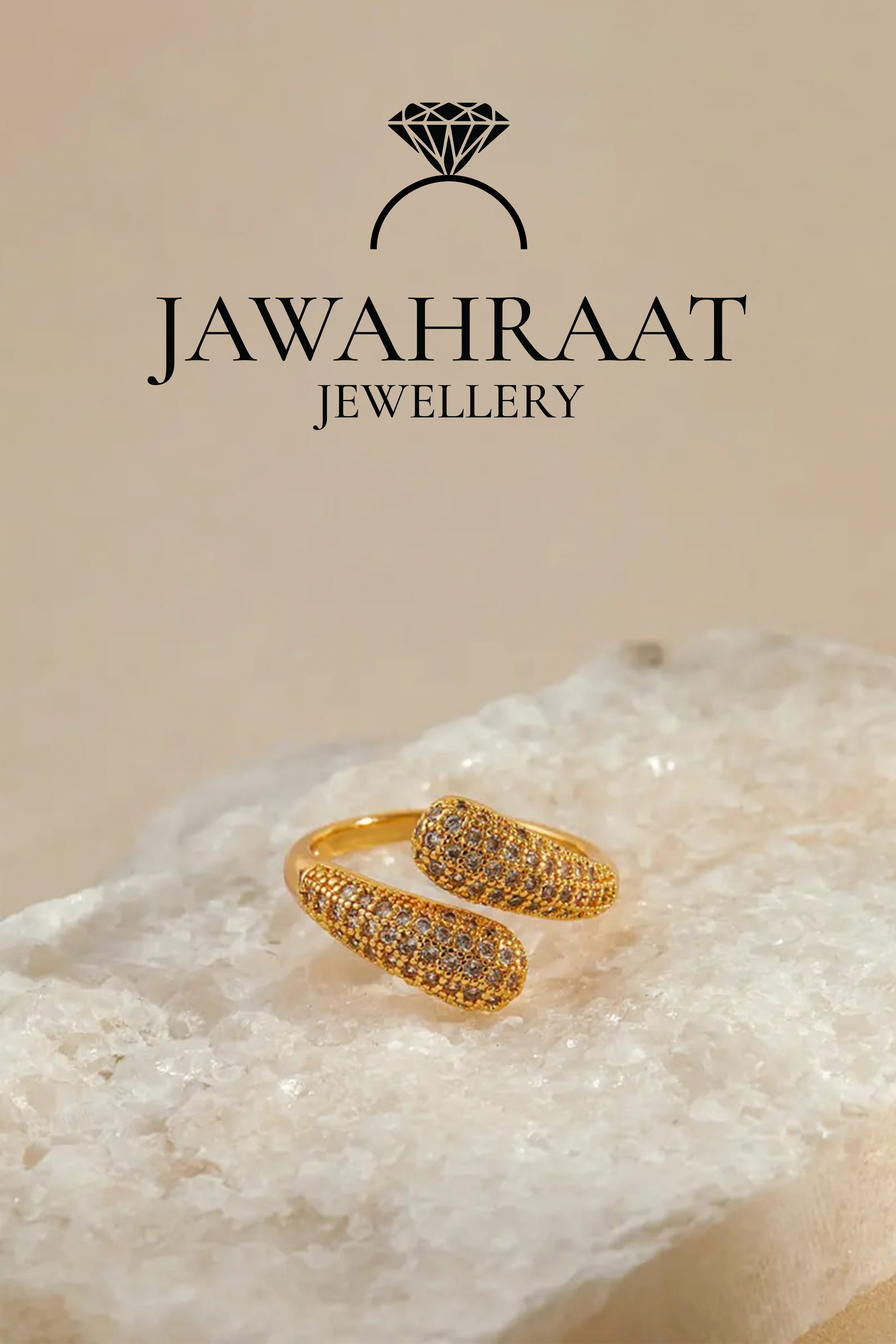 Front view of gold-toned twist ring by Jawahraat Jewellery, showcasing the full twisted band design and sparkling crystals against a flat background.

