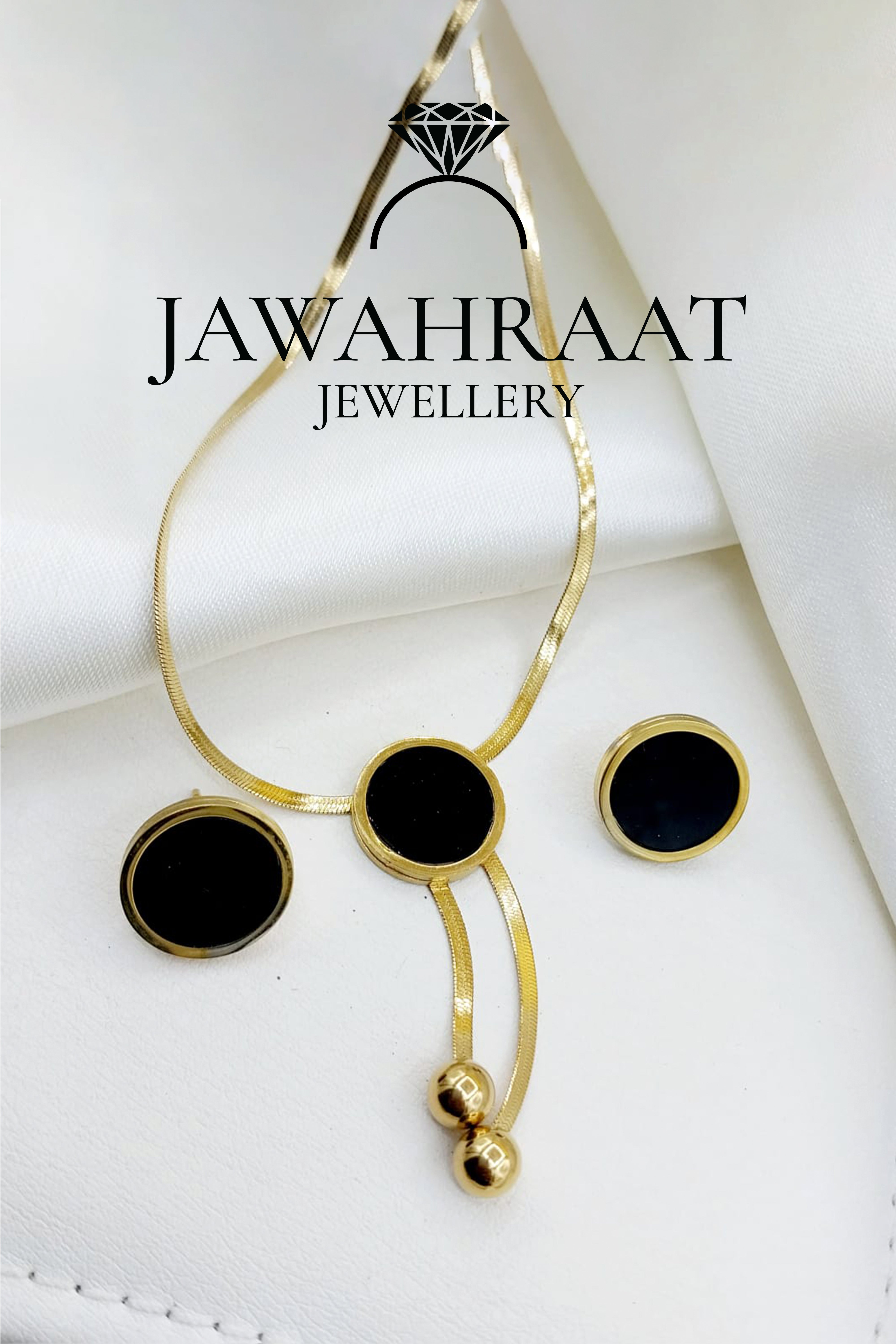 Gold-toned necklace and matching dangle earrings set by Jawahraat Jewellery, featuring bold black bead accents and intricate detailing — perfect for festive or formal occasions.

