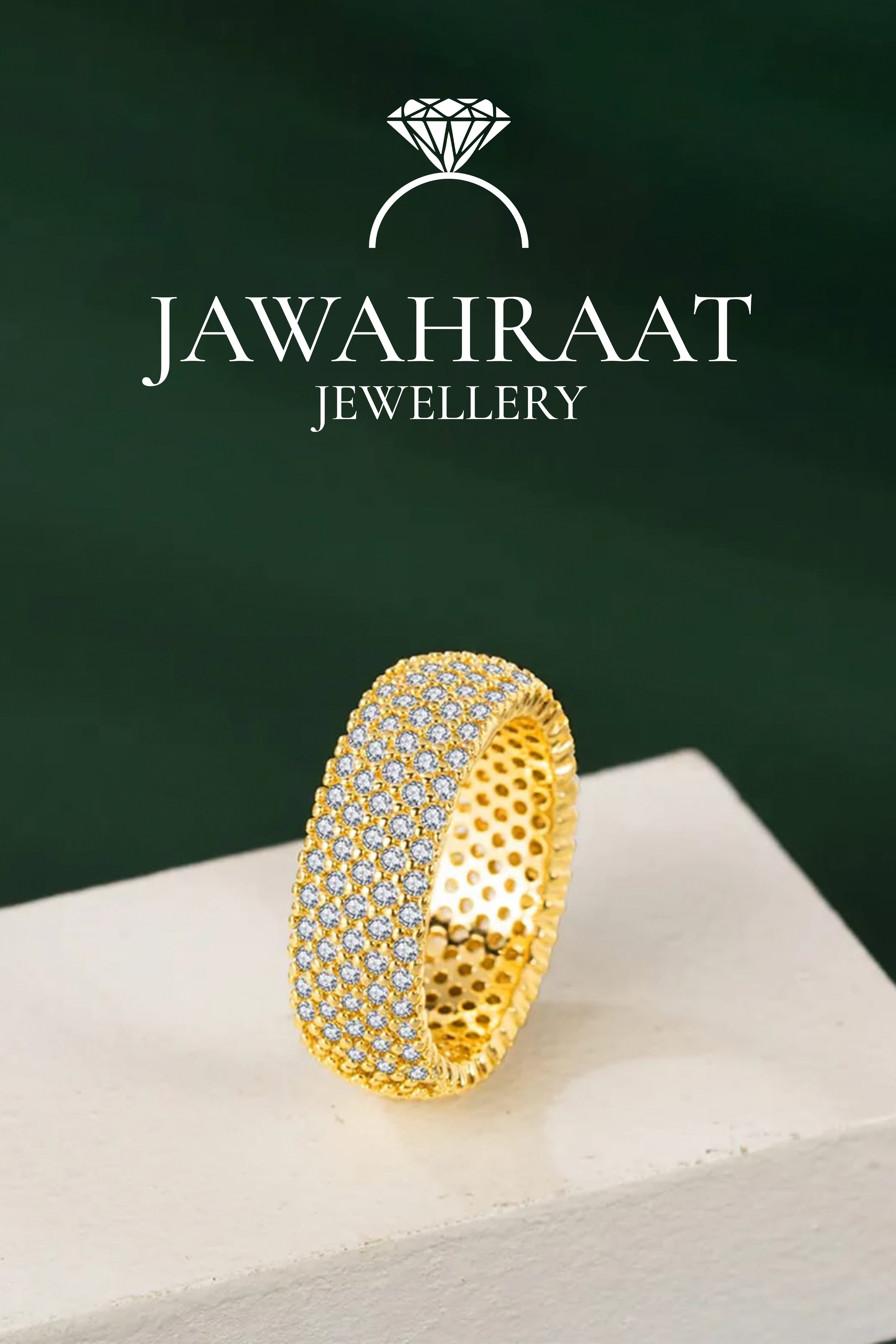 Front view of gold-toned band ring by Jawahraat Jewellery, showcasing a wide surface encrusted with shimmering crystals for a luxurious look.

