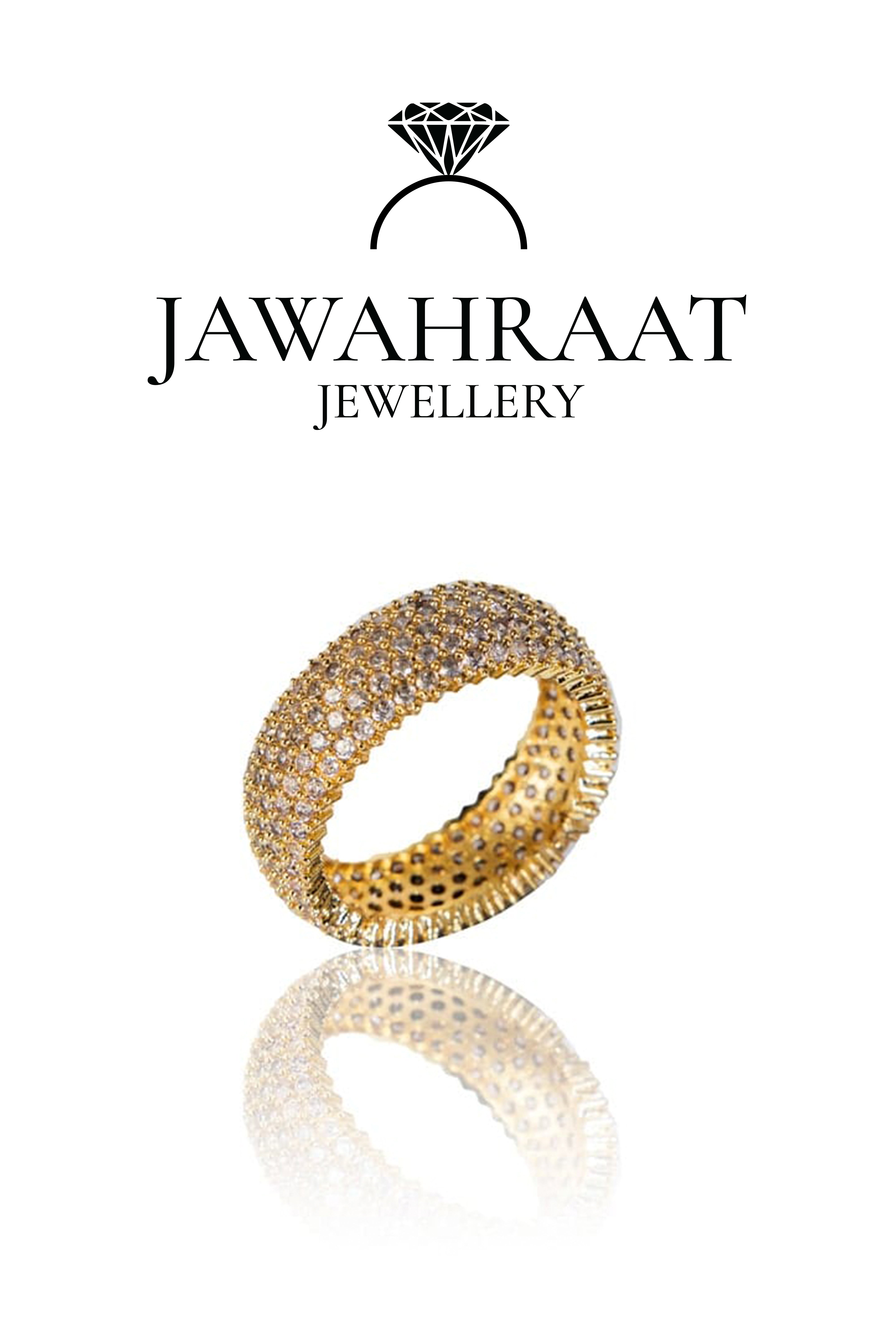 Side view of gold-toned crystal band ring by Jawahraat Jewellery, highlighting the ring's thick profile and elegant crystal detailing along the curved surface.

