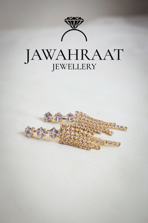 Front view of gold-tone multi-chain dangle earrings by Jawahraat Jewellery, featuring delicate hanging chains with sparkling rhinestone accents for a graceful, stylish look.


