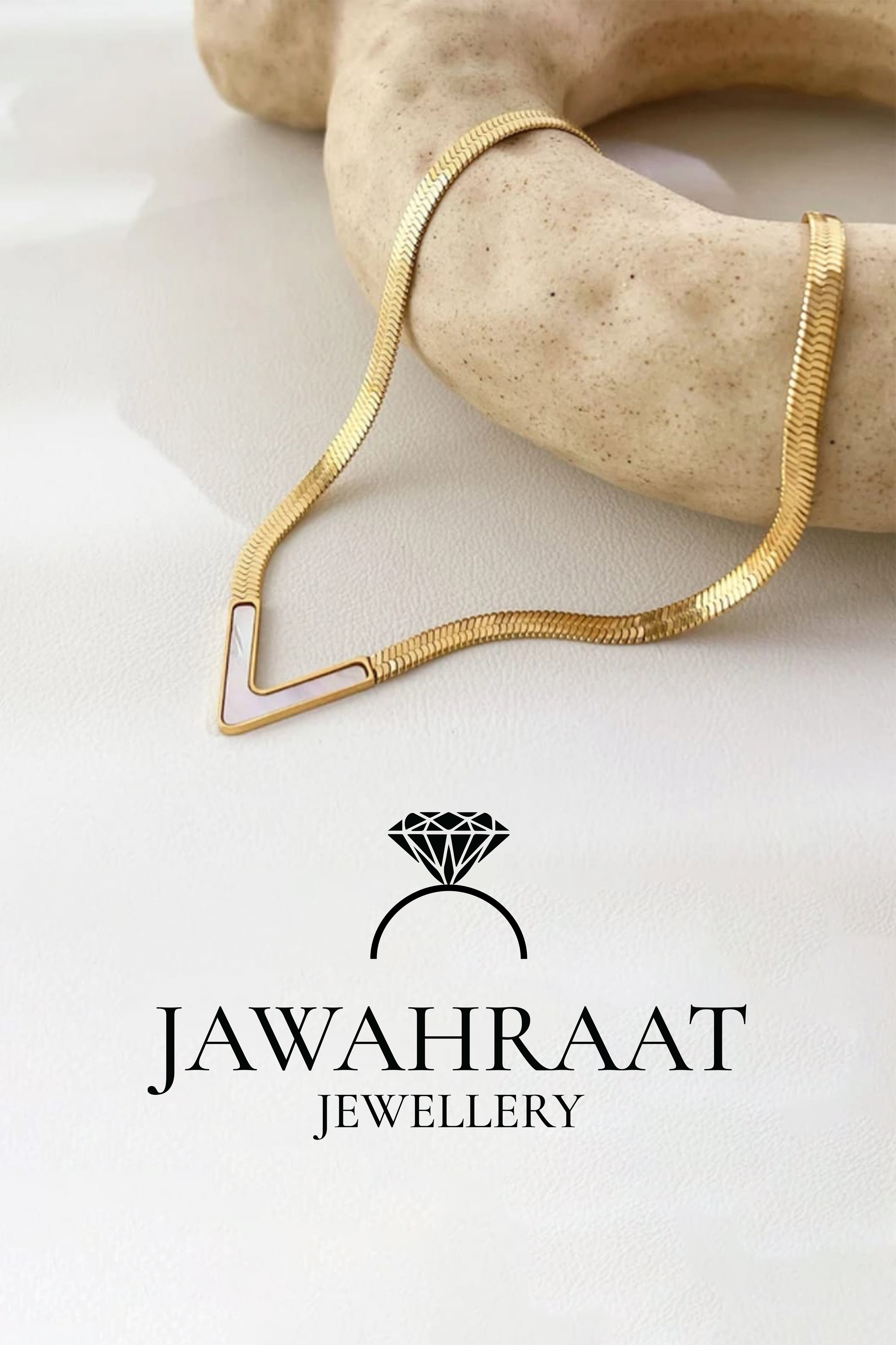 Front view of gold-toned V-shaped statement necklace by Jawahraat Jewellery, featuring a flat chain and glossy enamel inlay centerpiece — ideal for bold, modern styling.

