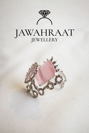 Side view of the Elara ring in blush pink by Jawahraat Jewellery – romantic silver-tone adjustable ring with central rectangular stone and pave accents.

