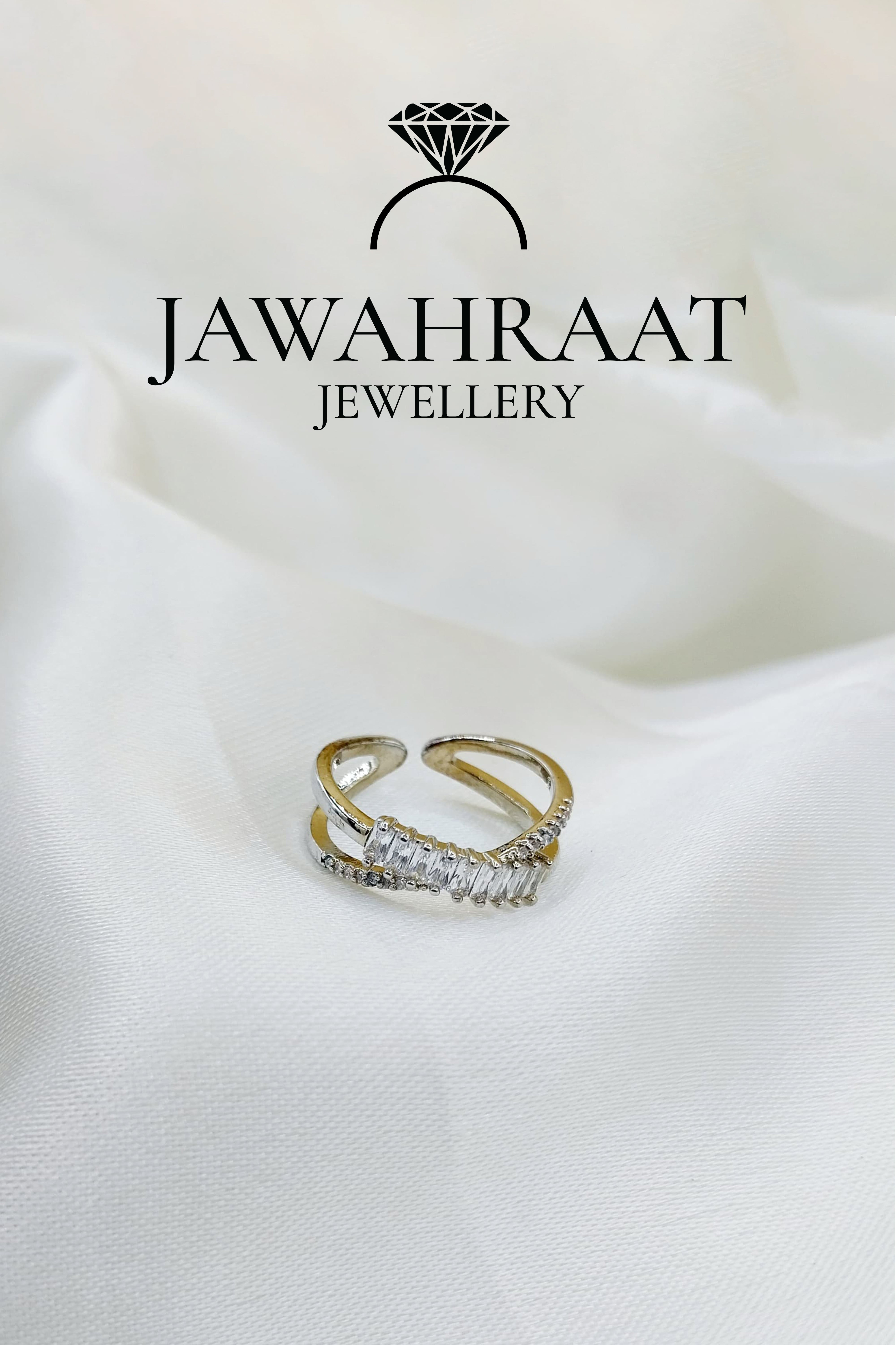 Silver-toned crystal cross ring by Jawahraat Jewellery, showcasing an elegant intersecting band design with shimmering crystal accents.

