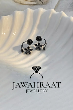 Black flower drop and pearl stud earrings set displayed on satin background, premium artificial jewellery by Jawahraat Jewellery