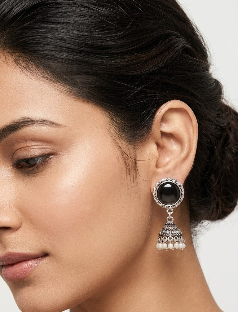 Woman wearing black stone oxidized jhumka earrings with traditional ethnic outfit