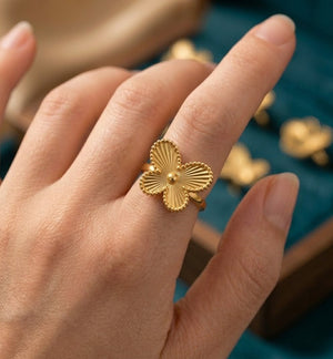 Gold plated butterfly ring with textured design worn on finger