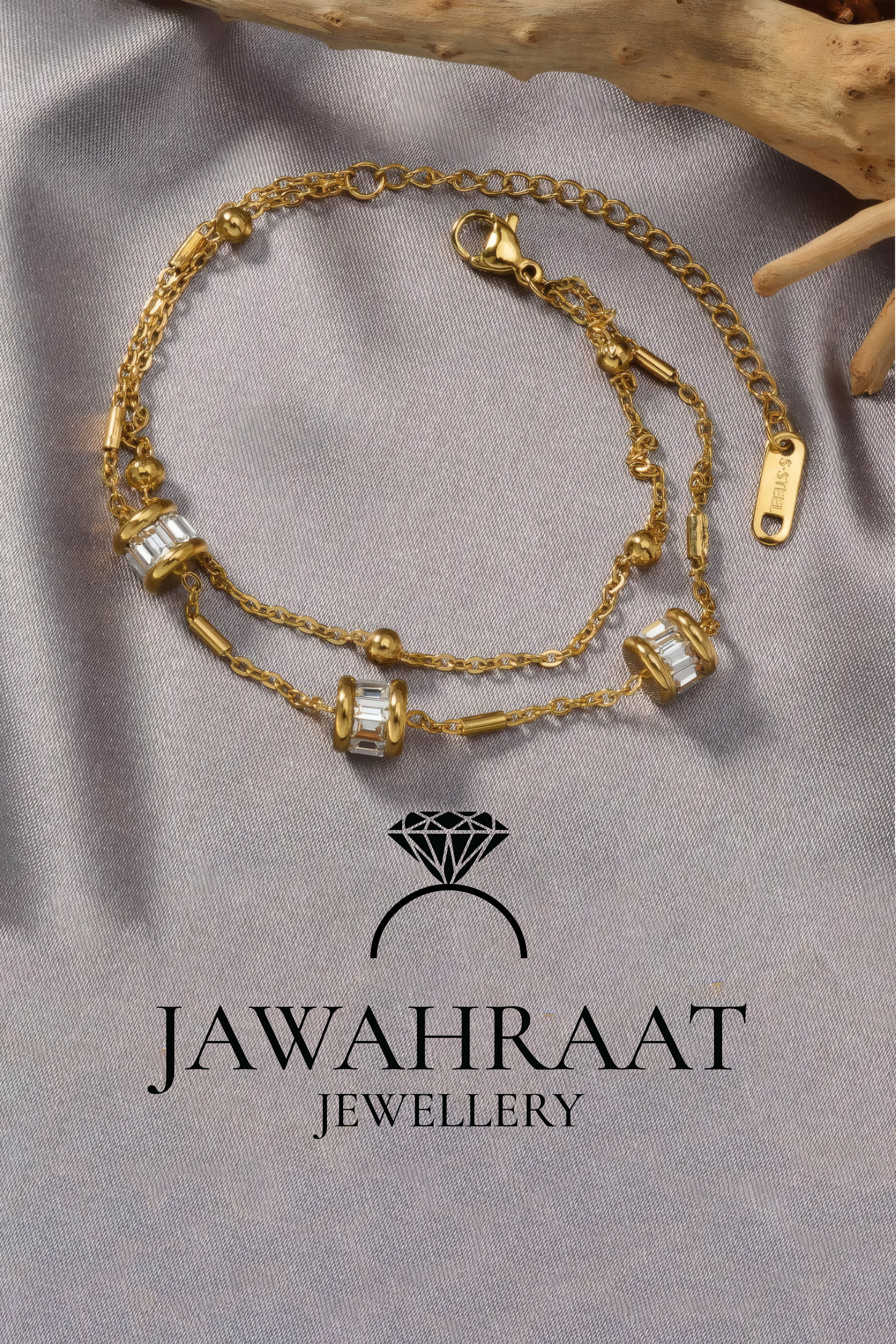 Close-up of Jawahraat Jewellery artificial gold-tone double-layer bracelet with baguette CZ barrel charms