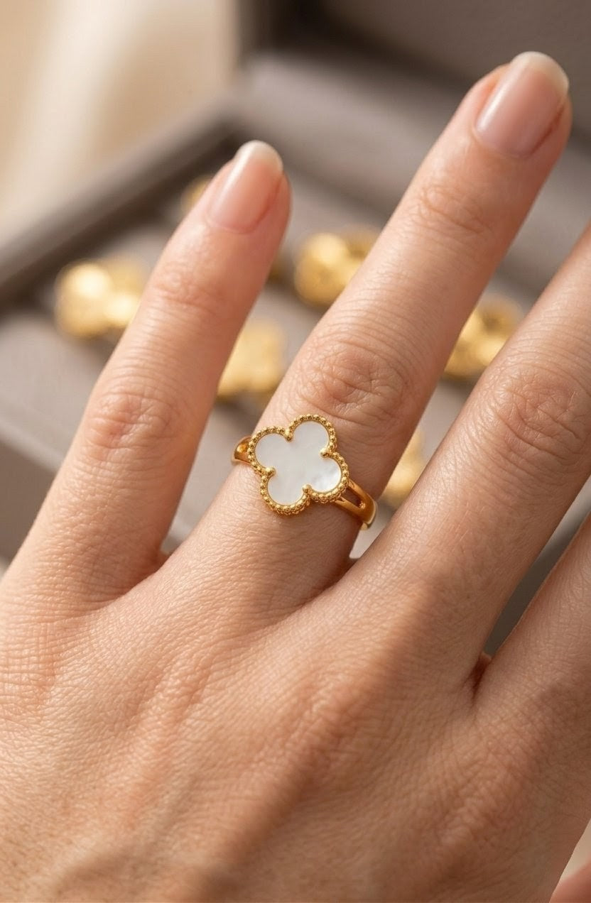 Gold plated clover leaf ring with white stone worn on finger
