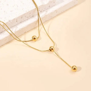 Double layer gold necklace with ball details close-up