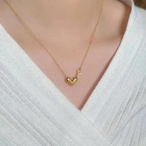 Gold heart necklace worn on neck
