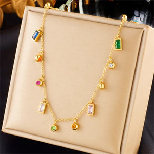 Multi color gemstone charm necklace displayed on stand