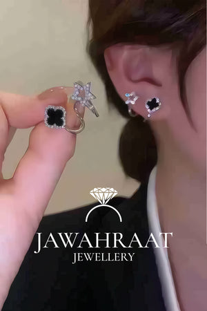 Black clover and silver star stud earrings worn on ear with sparkling CZ diamonds by Jawahraat Jewellery premium artificial jewellery