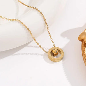 Gold plated Roman numeral double ring pendant necklace on white background