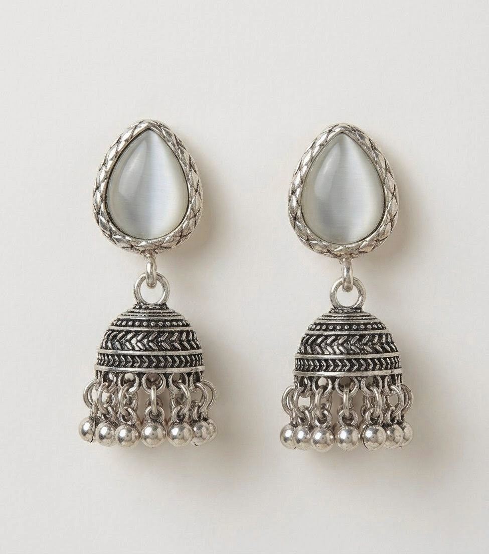 Pair of silver oxidized jhumka earrings showing full design and detailing